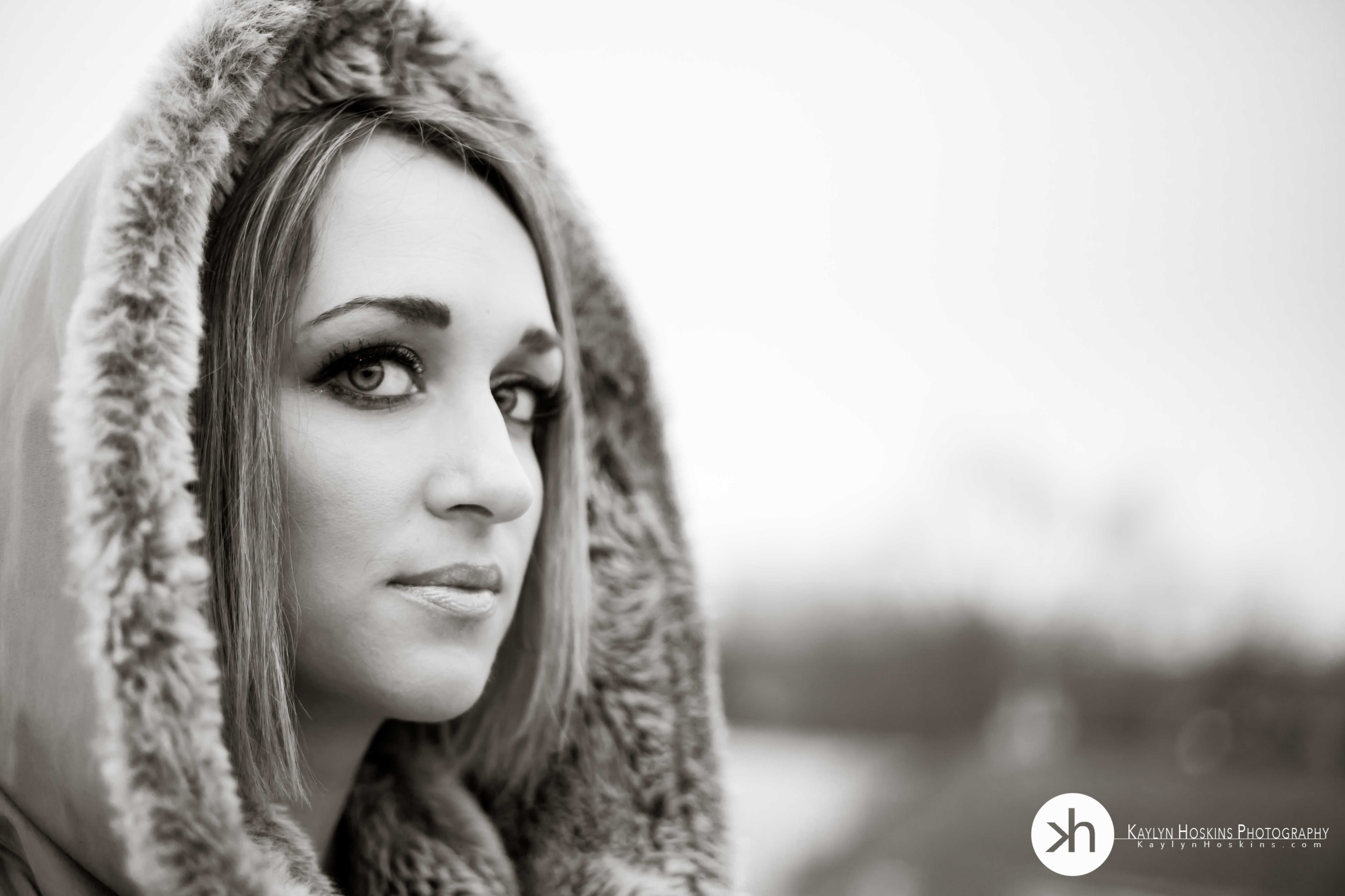 beautiful woman wearing winter hood during outdoor boudoir session