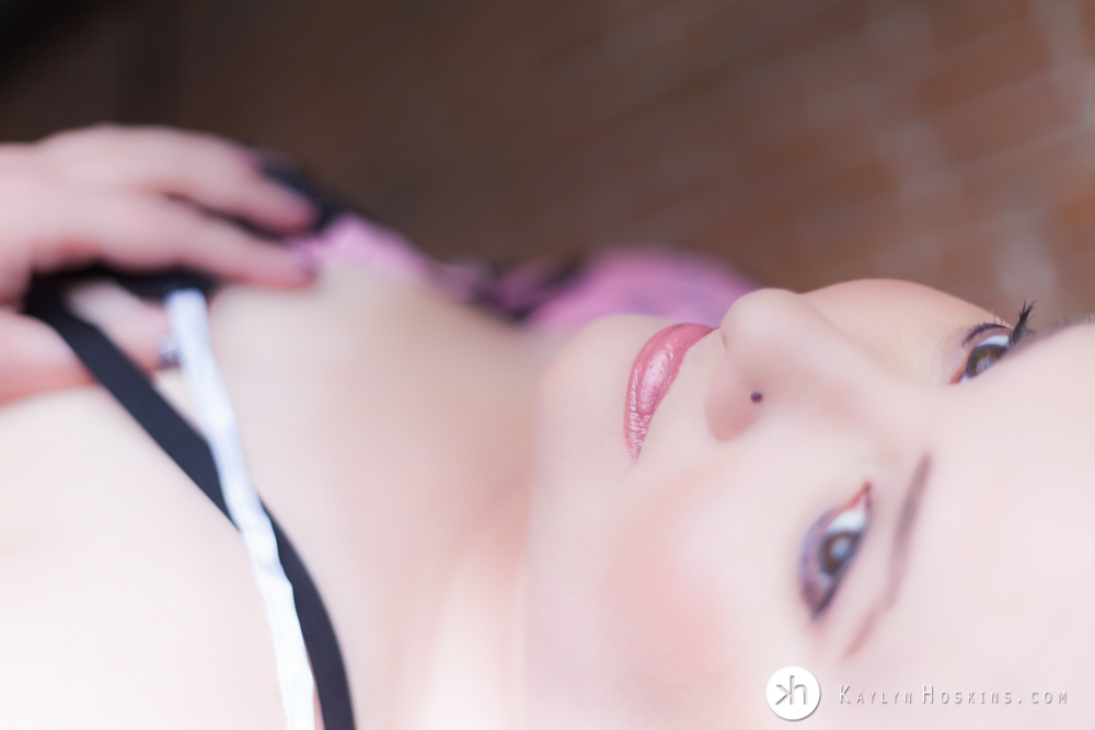 Boudoir Goddess Mindy laying on bar in lingerie during boudoir experience