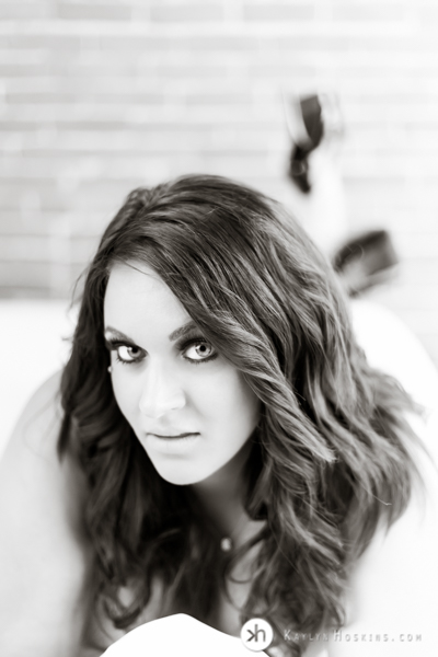 b & w of Boudoir Goddess laying on bed during boudoir experience at Kaylyn Hoskins Photography 