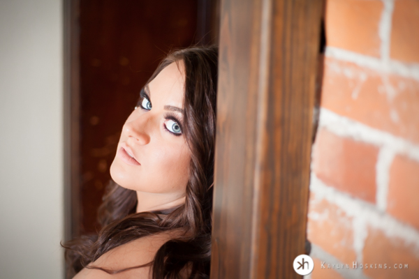 Gorgeous Boudoir Goddess sitting in doorway looking back at camera with her crazy beautiful blue eyes