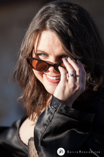 Boudoir Goddess looks over her sunglasses playfully during photo shoot at Kaylyn Hoskins Photography