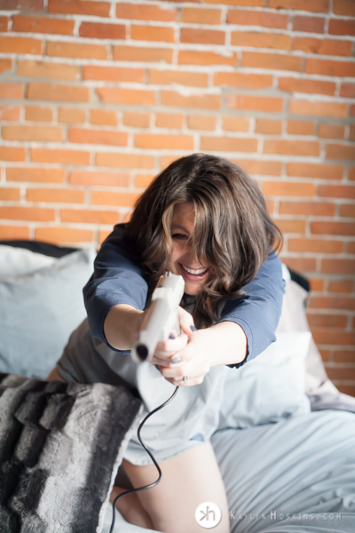 Boudoir Goddess point duck hunt gun at camera during boudoir experience at Kaylyn Hoskins Photography