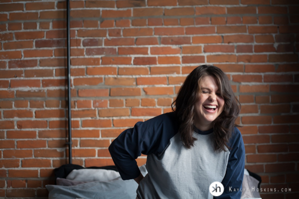 Boudoir Goddess beautifully laughing on the bed during boudoir shoot 