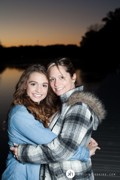 Solon Senior hugs Mom during sunset on the dock at P. Sue Beckwith, M.D., Boathouse during senior photos