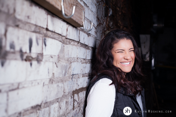 Prairie Senior giggles during senior portraits downtown Iowa City