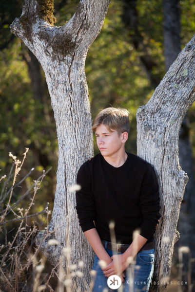 Vacaville Senior leans up against tree during senior photos