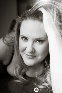 Gorgeous Goddess laying on bar with hand in hair during boudoir shoot in Solon, Iowa