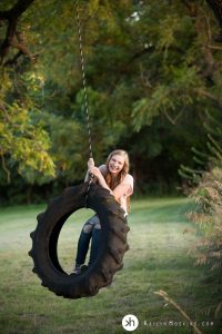 Gorgeous Senior Gracen playing on tire swing during senior photos