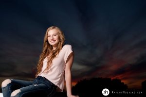 Solon Senior above the trees at sunset during senior photo session