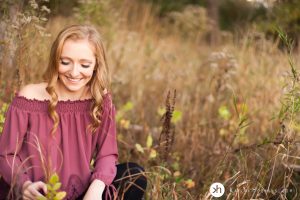 Solon Senior playfully looks down at weeds during her fall senior session