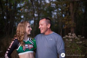 Solon Senior Olivia and her Father looking at each other by lake macbride during photo shoot