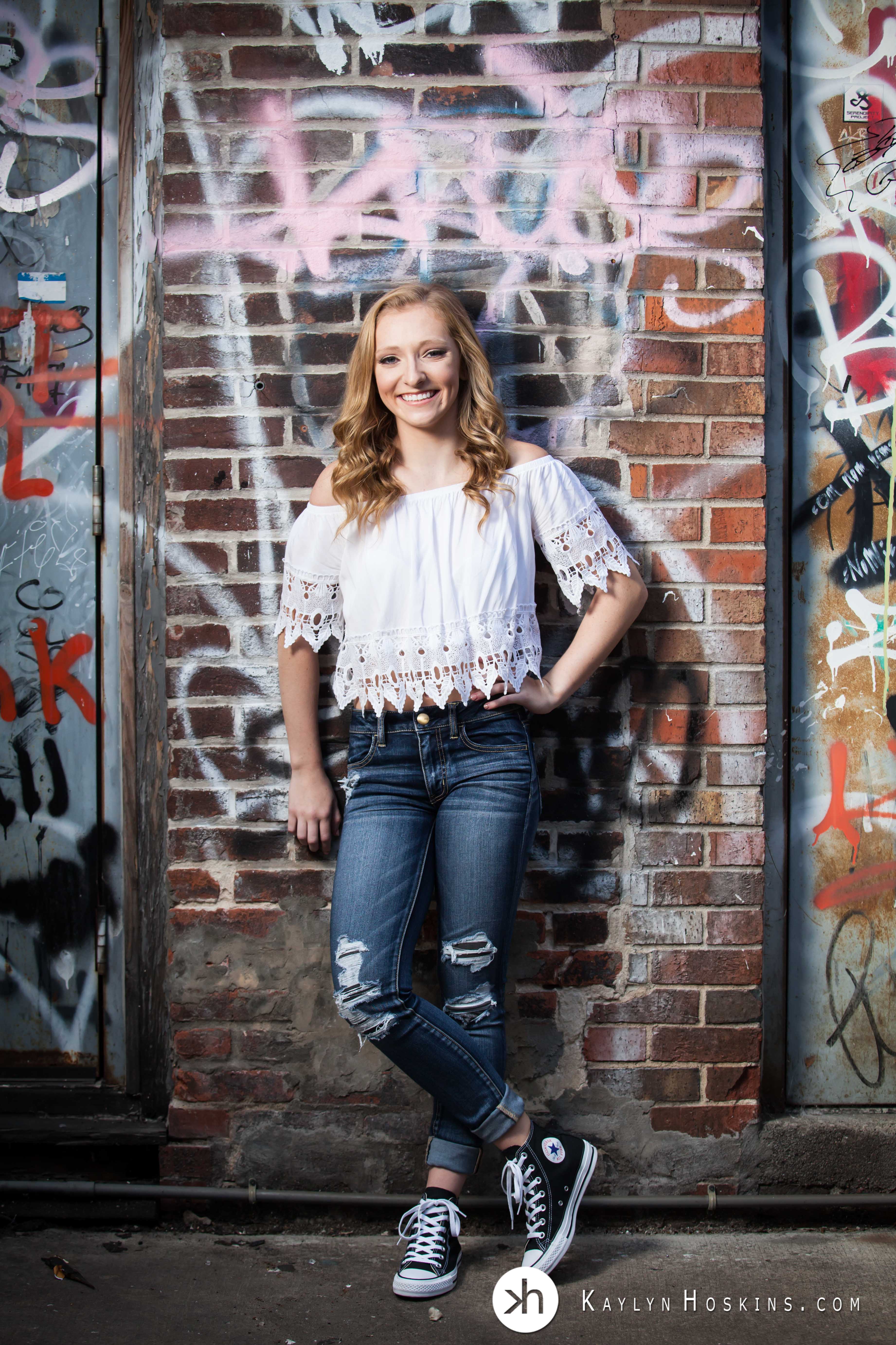Solon Senior standing in front of Graffiti wall in Alley downtown Iowa City