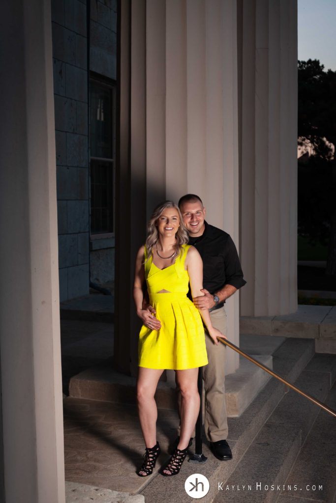 Beautiful engaged couple standing on steps of Old Capital in Iowa City