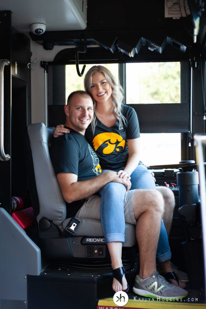 Andrea sits on her fiance's lap in Cambus drivers seat during engagement photo shoot