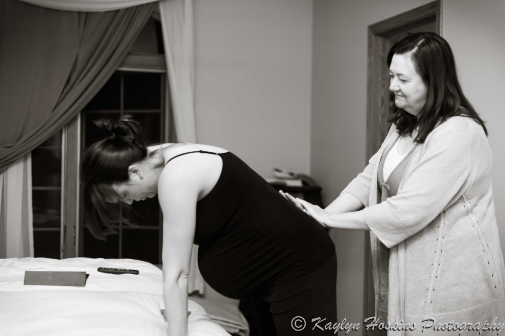 Midwife assisting home birth Mother before water birth