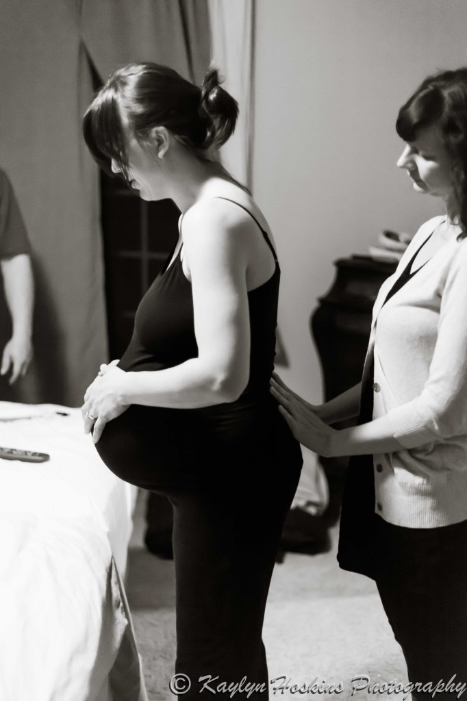 Midwife assisting home birth Mother before water birth