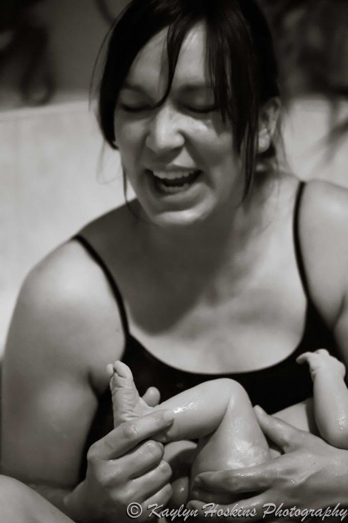 Home water birth Mama adores her little man's feet for the first time