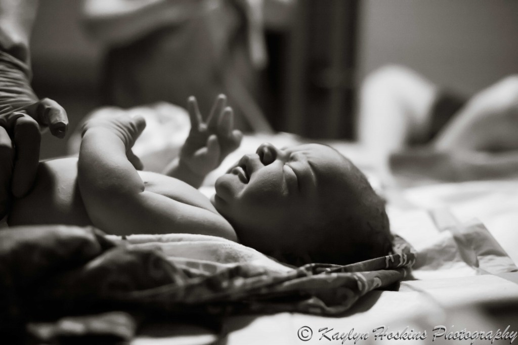 Newborn boy gets looked over by midwives