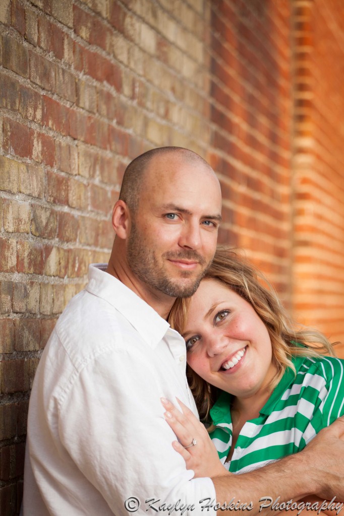 bride to be leans her head on fiance's chest during photo shoot