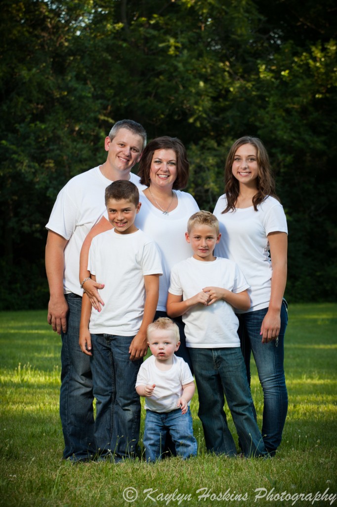 The Lang Family pose for their family pictures in the green grass