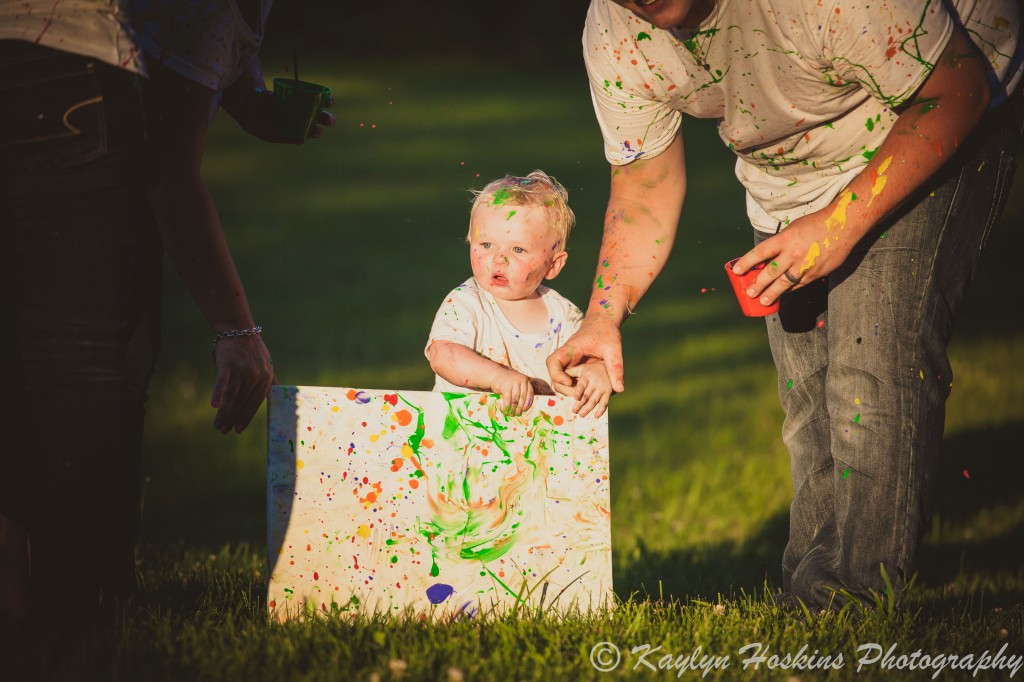 Baby brother shows his artwork during family pictures paint fight with Kaylyn Hoskins