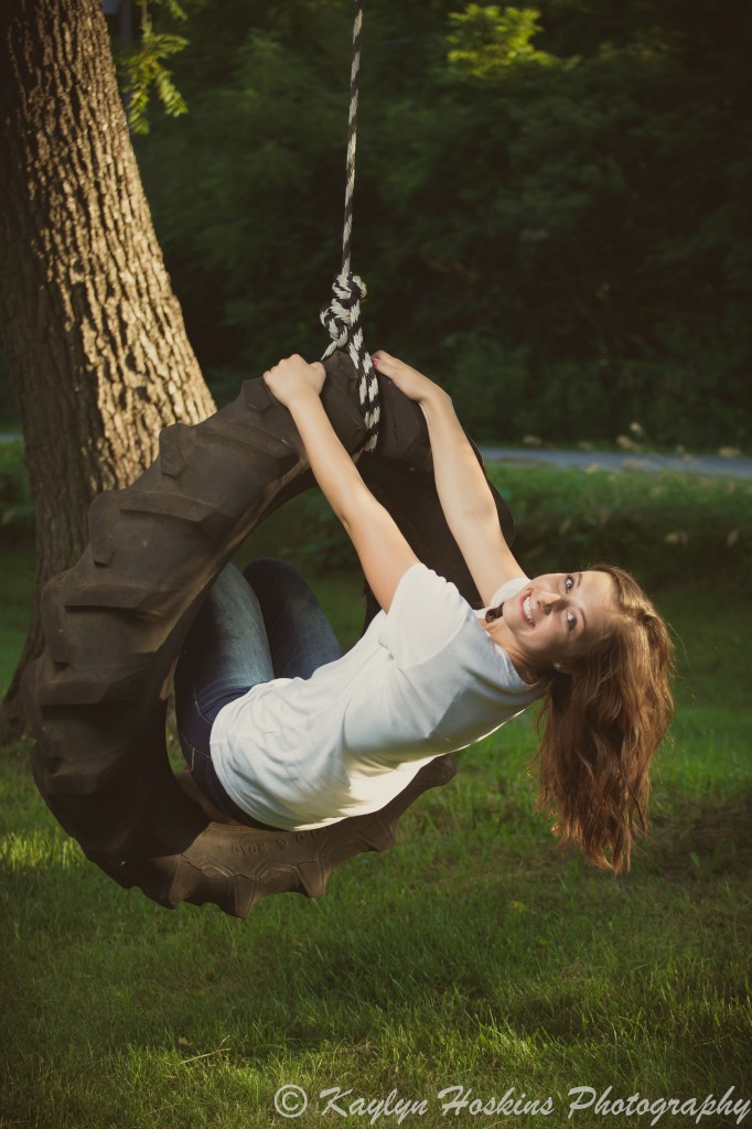 Daughter plays on tire swing during family pictures with Kaylyn Hoskins Photography