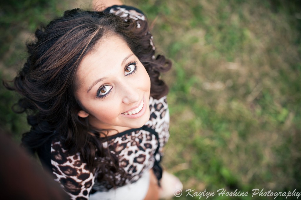 Gorgeous Senior smiles and looks up at the camera during senior photo session with Kaylyn Hoskins Photography at Harvest Preserve in Iowa City