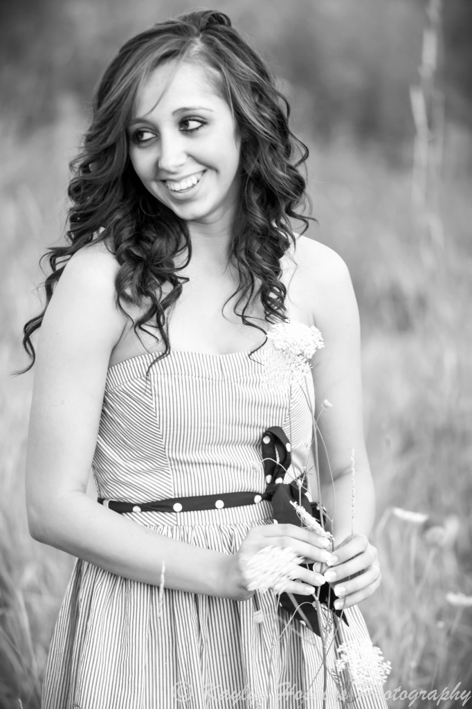 The Gorgeous Addie plays with queen anne's lace during her senior pics with Kaylyn Hoskins Photography