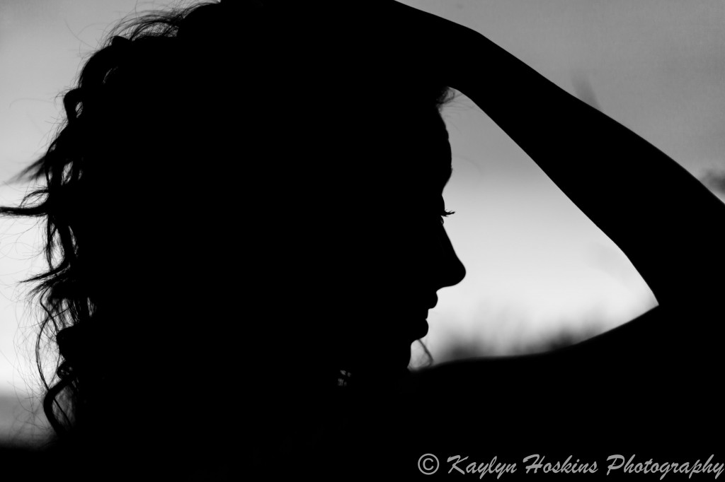 Solon Senior Addie runs hand thru her hair for a fun silhouette pic during her senior session with Kaylyn Hoskins Photography at Harvest Preserve in Iowa City