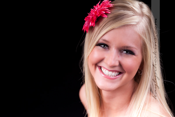 Lacie Joy genuinely smiles at the camera directed during her boudoir photography session with Kaylyn Hoskins Photography