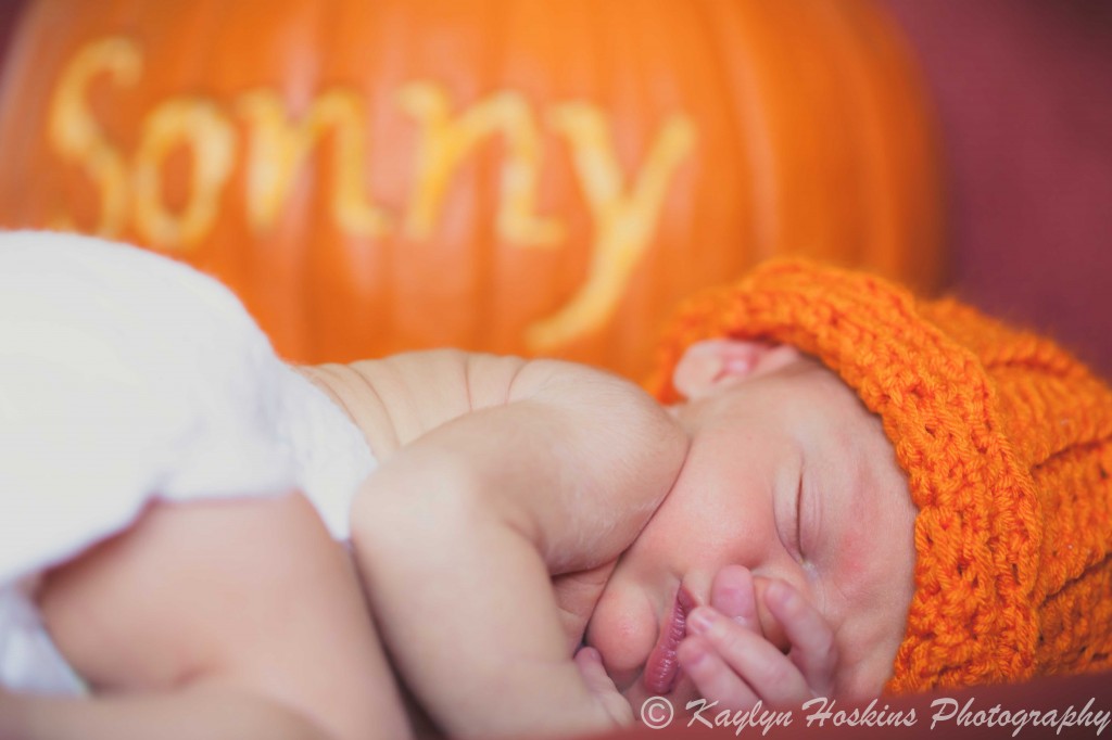 newborn Sonny with pumpkin hat on