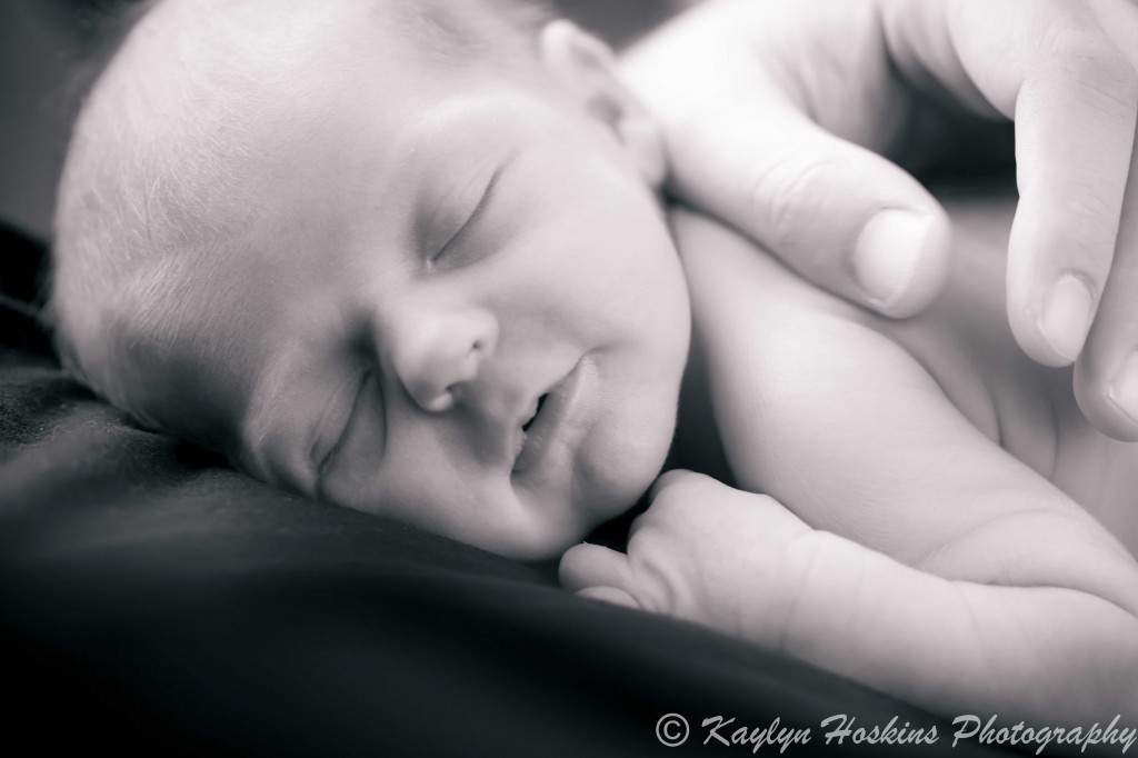 newborn boy resting on dad's chest