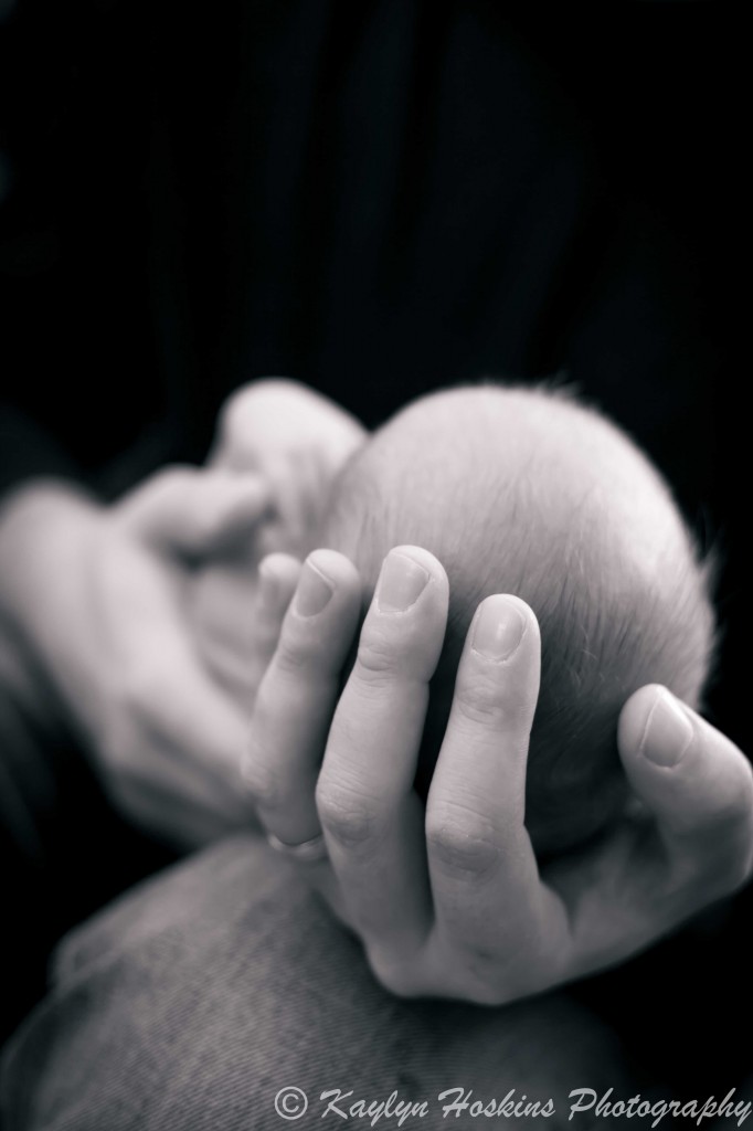 newborn baby boy in dad's hands