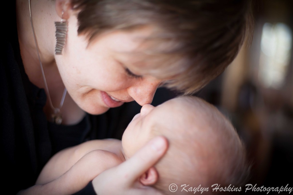 brand new Mom and newborn boy rubbing noses