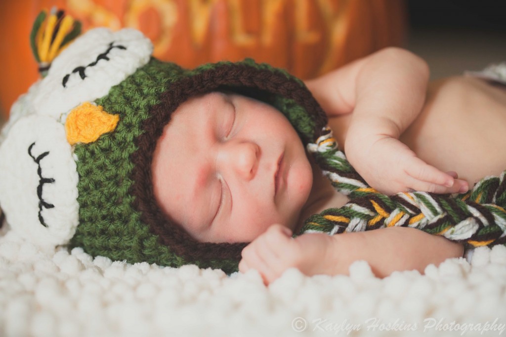 newborn boy sonny in hand made owl hat