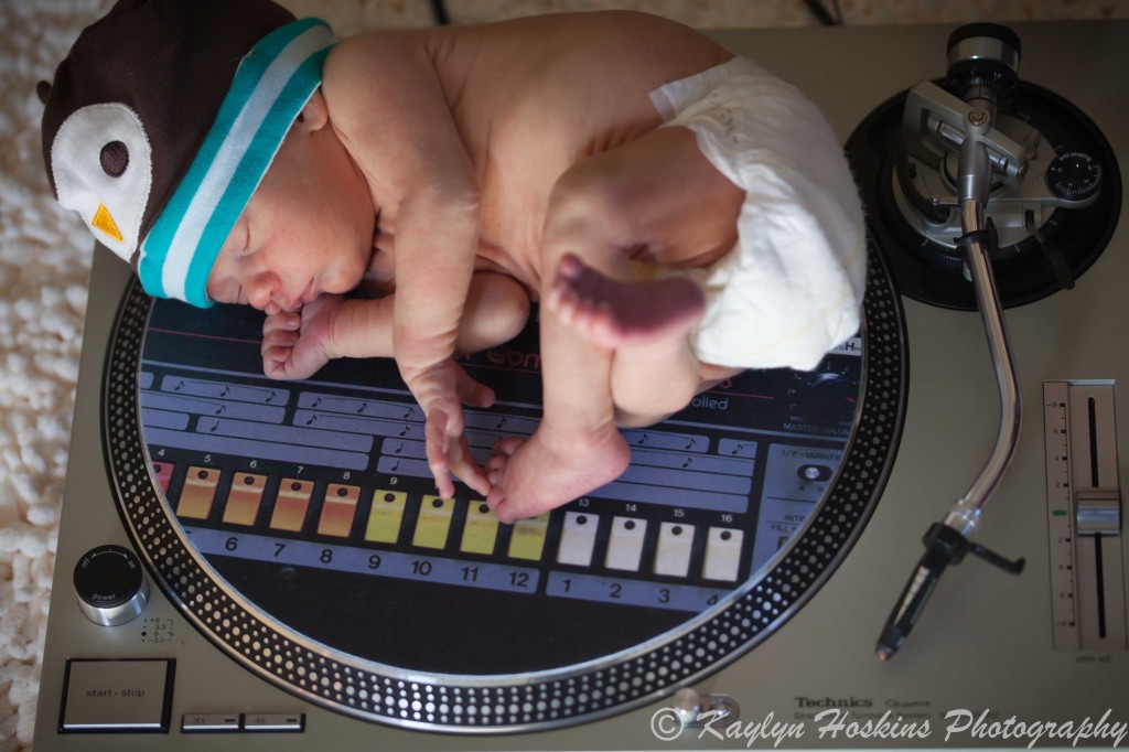 newborn boy on his dj dad's turntable