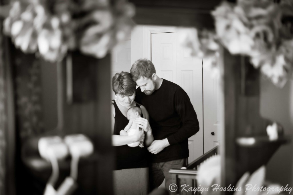 new mom and dad adoring their newborn baby boy in his nursery