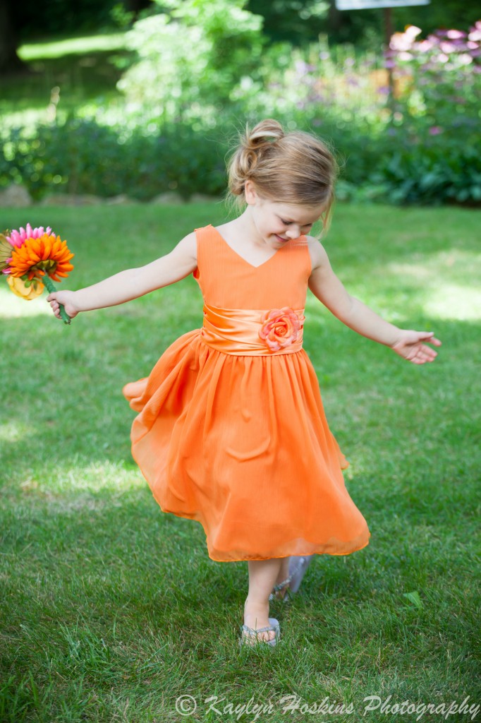 Beautiful little bridesmaid twirls in her dress before her Mom gets married at the Little Brown Church in Nashua, IA