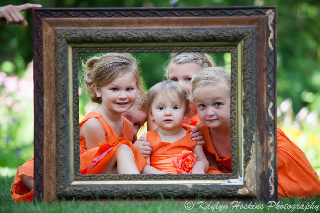 The adorable little ladies in a frame before the wedding at Little Brown Church in Nashua, IA