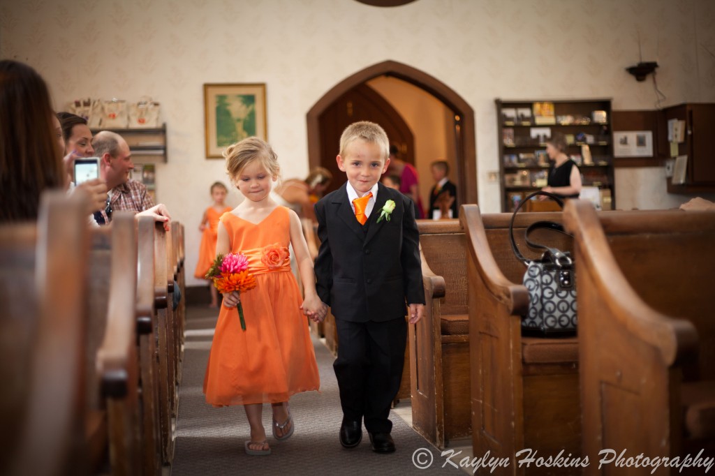 Sweet little kids walking up the isle for wedding at the Little Brown Church in Nashua, IA