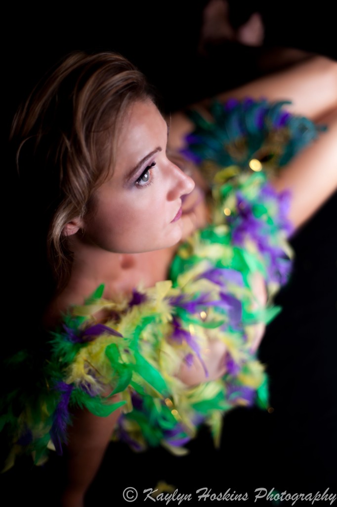 Gorgeous woman wrapped in boa during boudoir session