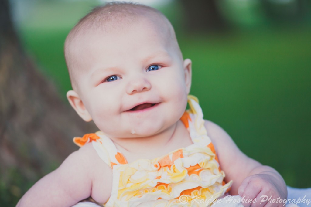 baby smiles big during family photos