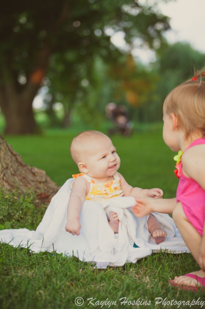 big sister wipes slobber off chin during family photos