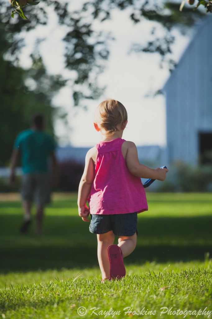 Daughter following her Dad telling him he forgot his phone during family photos