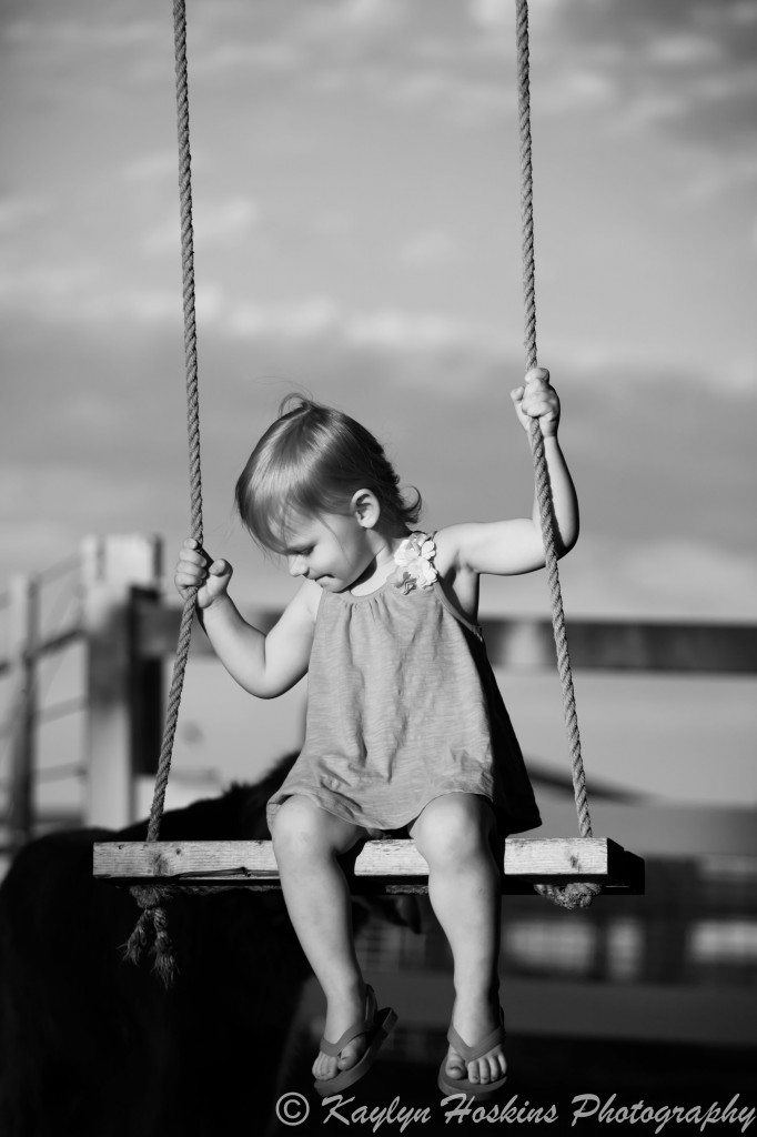 daughter swings during family photos