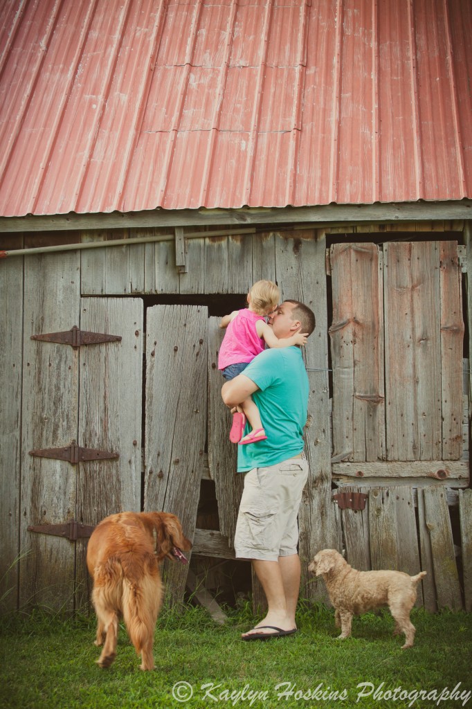 Dad and daughter look into old building during their family photos