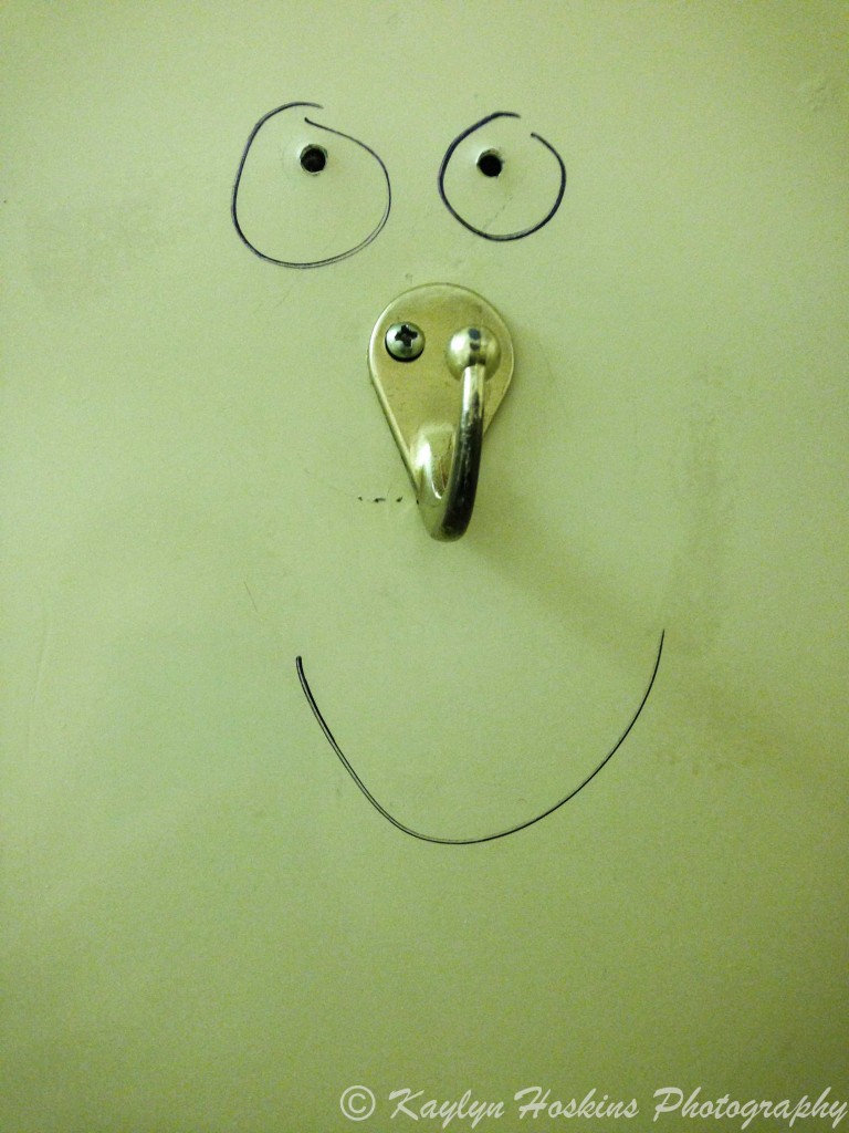 Fun face drawn on bathroom door hook