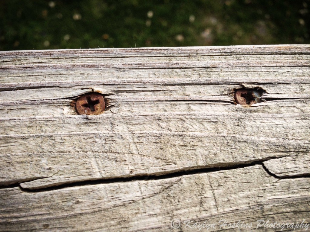 Fun Face in wood on porch railing